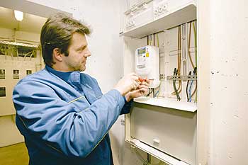 Mitarbeiter eines Stromlieferers bei der Montage des intelligenten Stromzählers