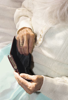 Rentnerin beim Blick in ihre leere Geldbörse