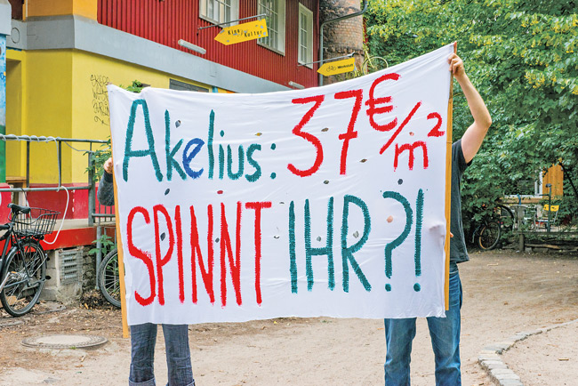 Akelius-Mieter mit Protest-Plakat